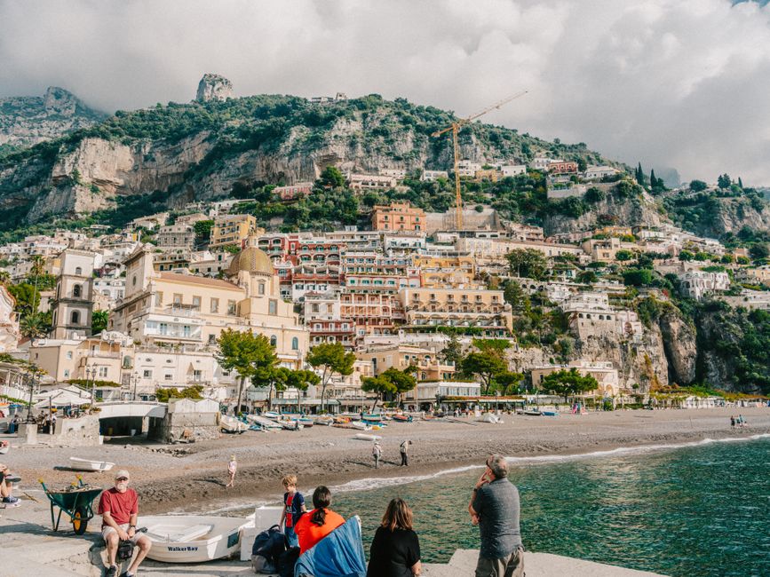 Captivating view of Positano's colorful hillside buildings over the beach and sea, Italy.
