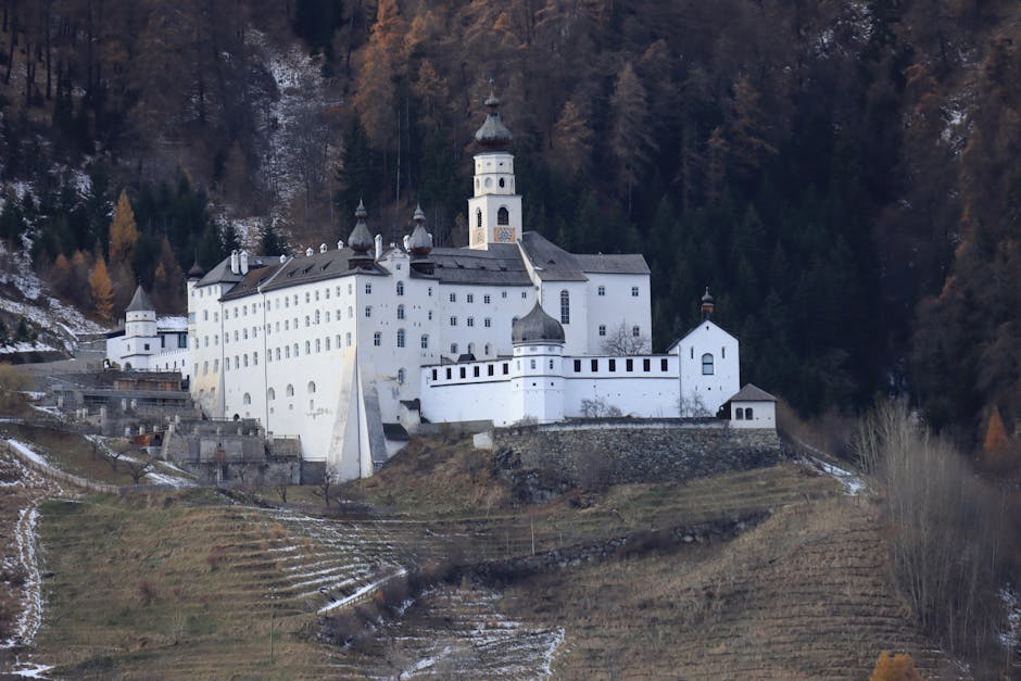 A stunning view of a historical castle in Sluderno, Italy surrounded by scenic landscapes.